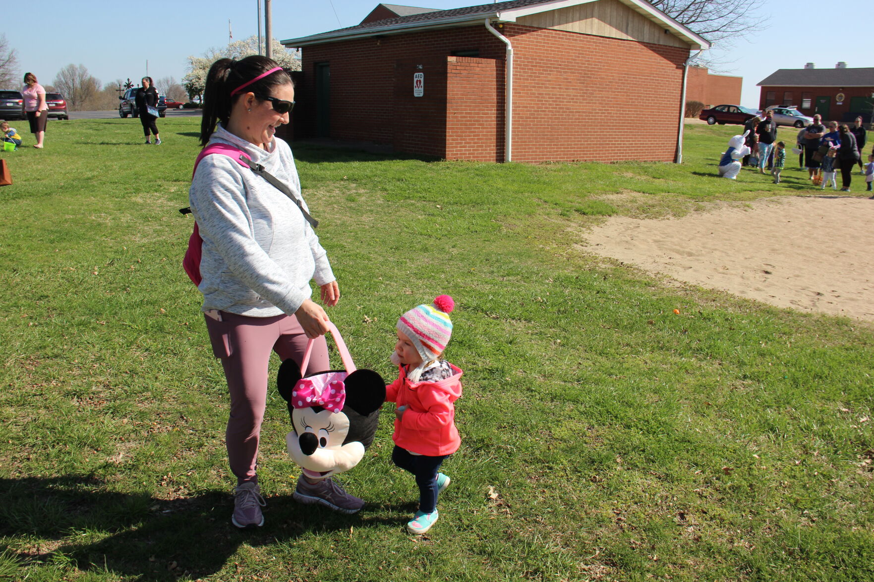 Brooklynn Feltmann hands an Easter egg to Jen Feltmann